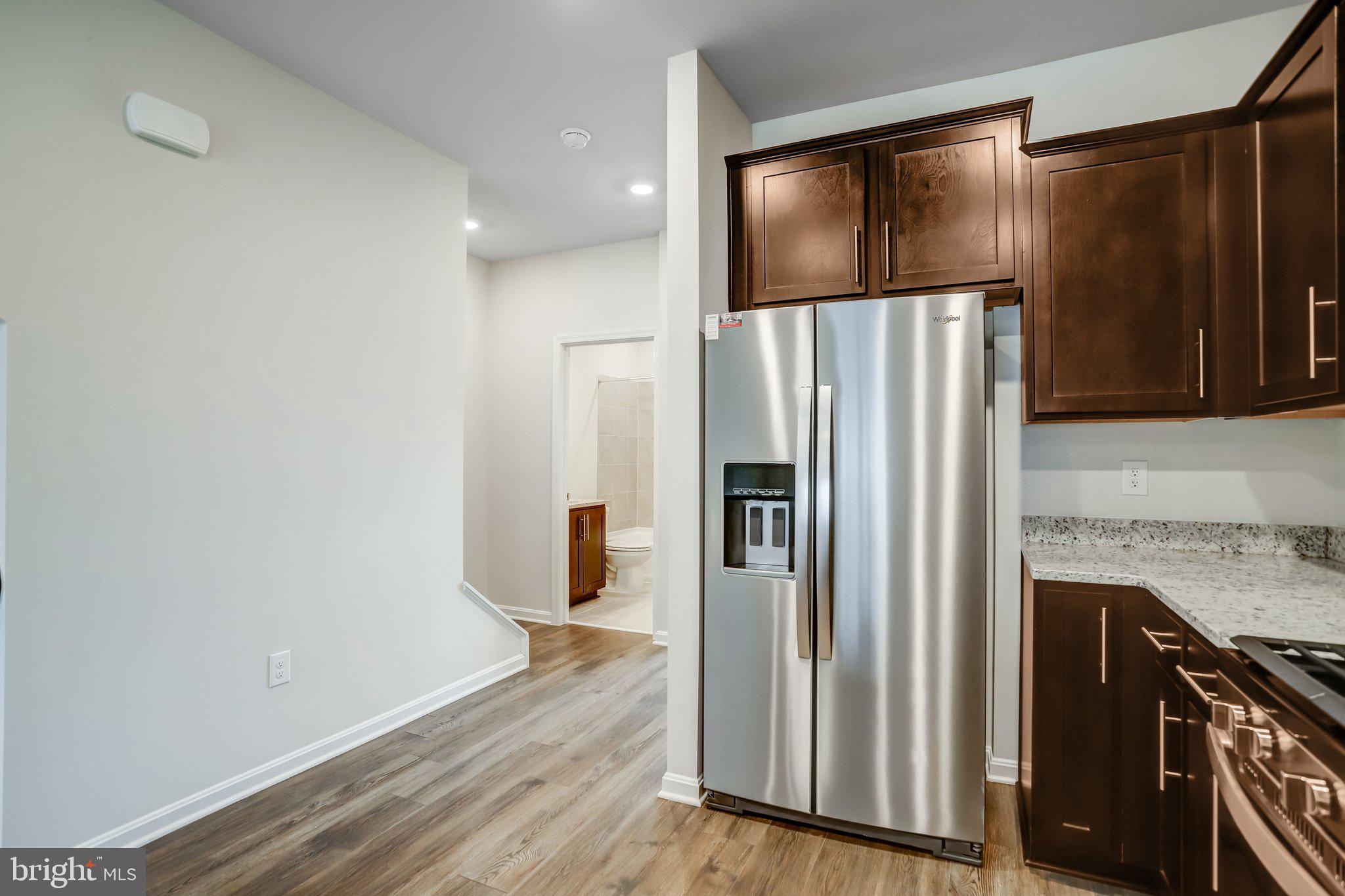 721 Courier Lane Frederick, MD 21701 - Photo 17 of 61 a kitchen with stainless steel appliances a refrigerator and wooden floor