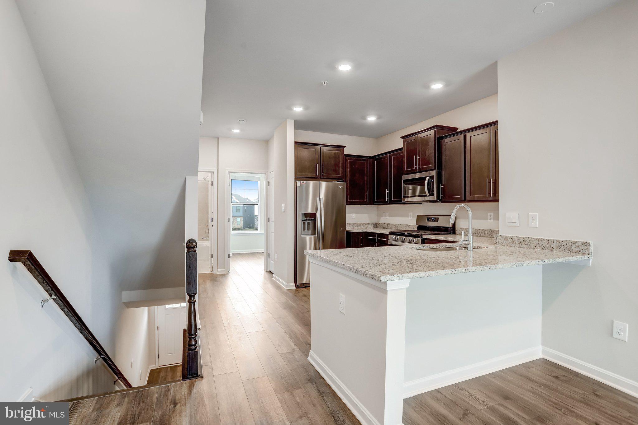721 Courier Lane Frederick, MD 21701 - Photo 18 of 61 a view of kitchen with stainless steel appliances refrigerator stove microwave and cabinets