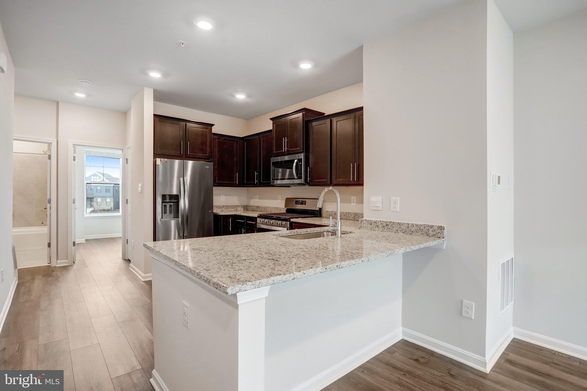 721 Courier Lane Frederick, MD 21701 - Photo 19 of 61 a kitchen with stainless steel appliances granite countertop a refrigerator a sink a stove and oven