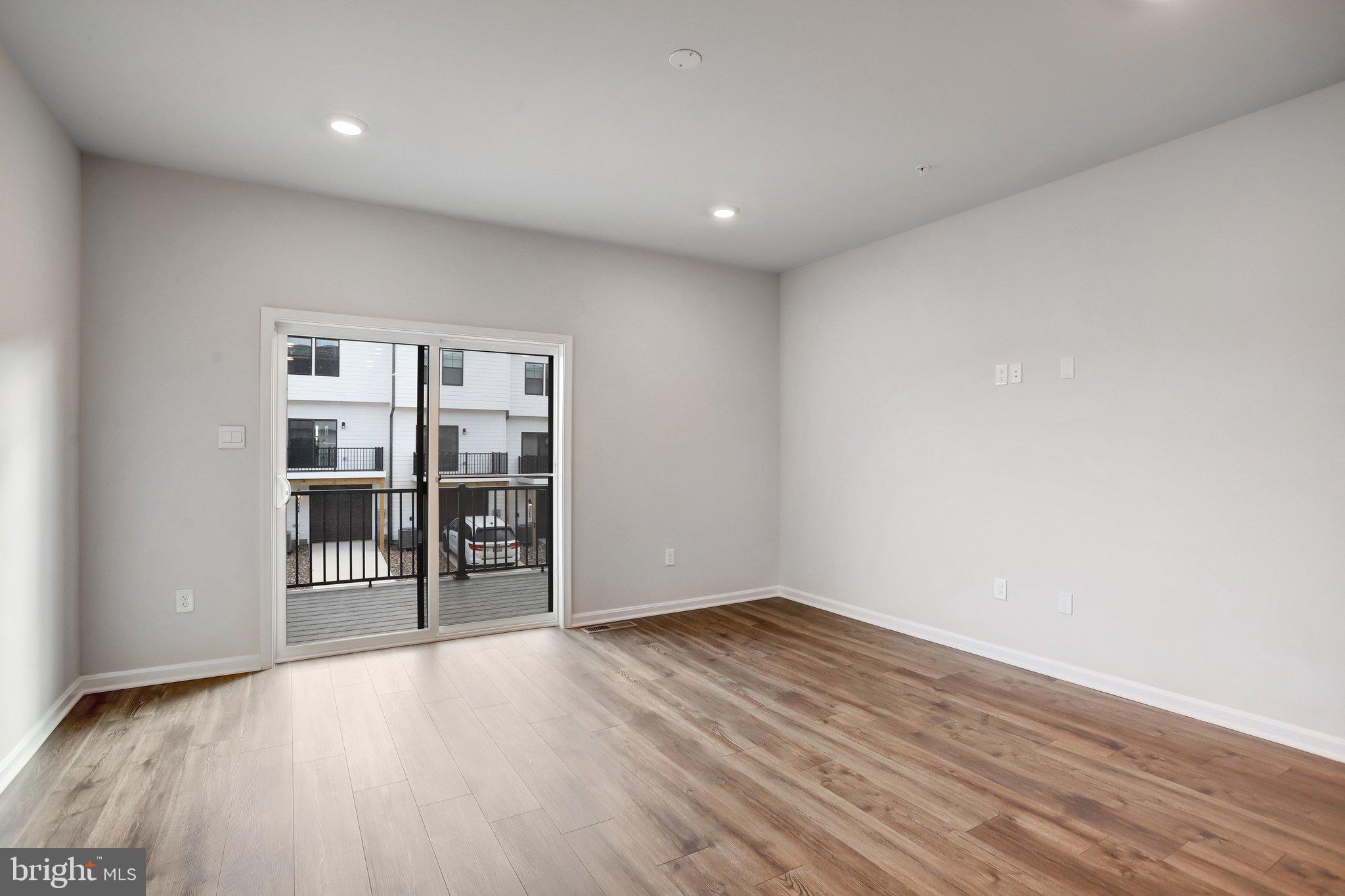 721 Courier Lane Frederick, MD 21701 - Photo 22 of 61 a view of empty room with wooden floor and cabinet
