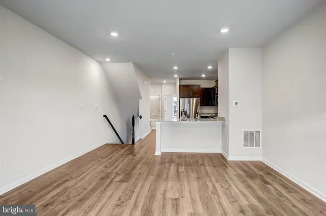 a view of a hallway with closet and wooden floor