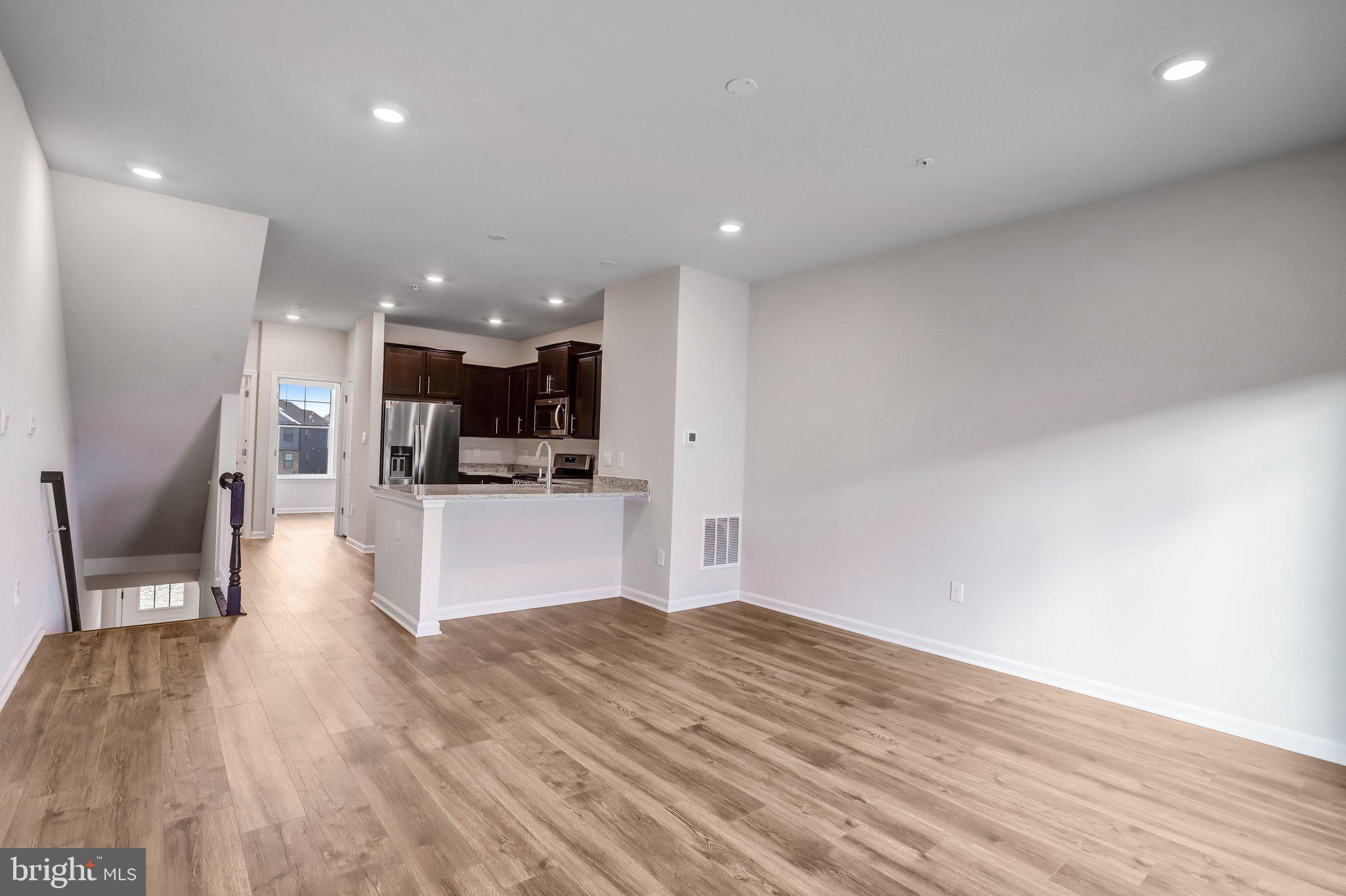 721 Courier Lane Frederick, MD 21701 - Photo 24 of 61 a view of kitchen and hall with wooden floor