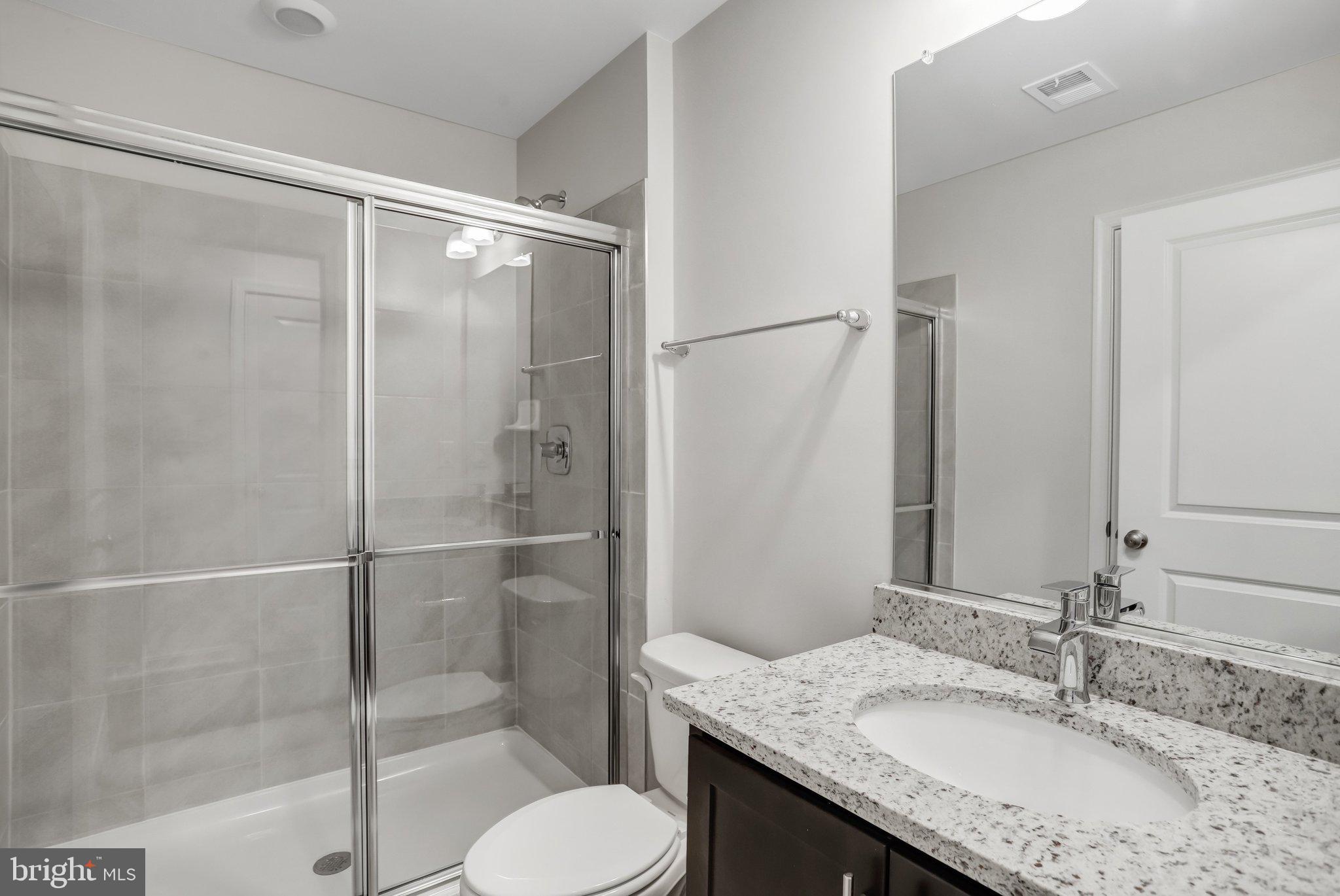 721 Courier Lane Frederick, MD 21701 - Photo 25 of 61 a bathroom with a granite countertop sink toilet and shower