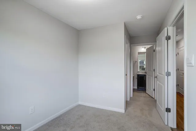 a bathroom with a granite countertop sink a toilet and a large mirror