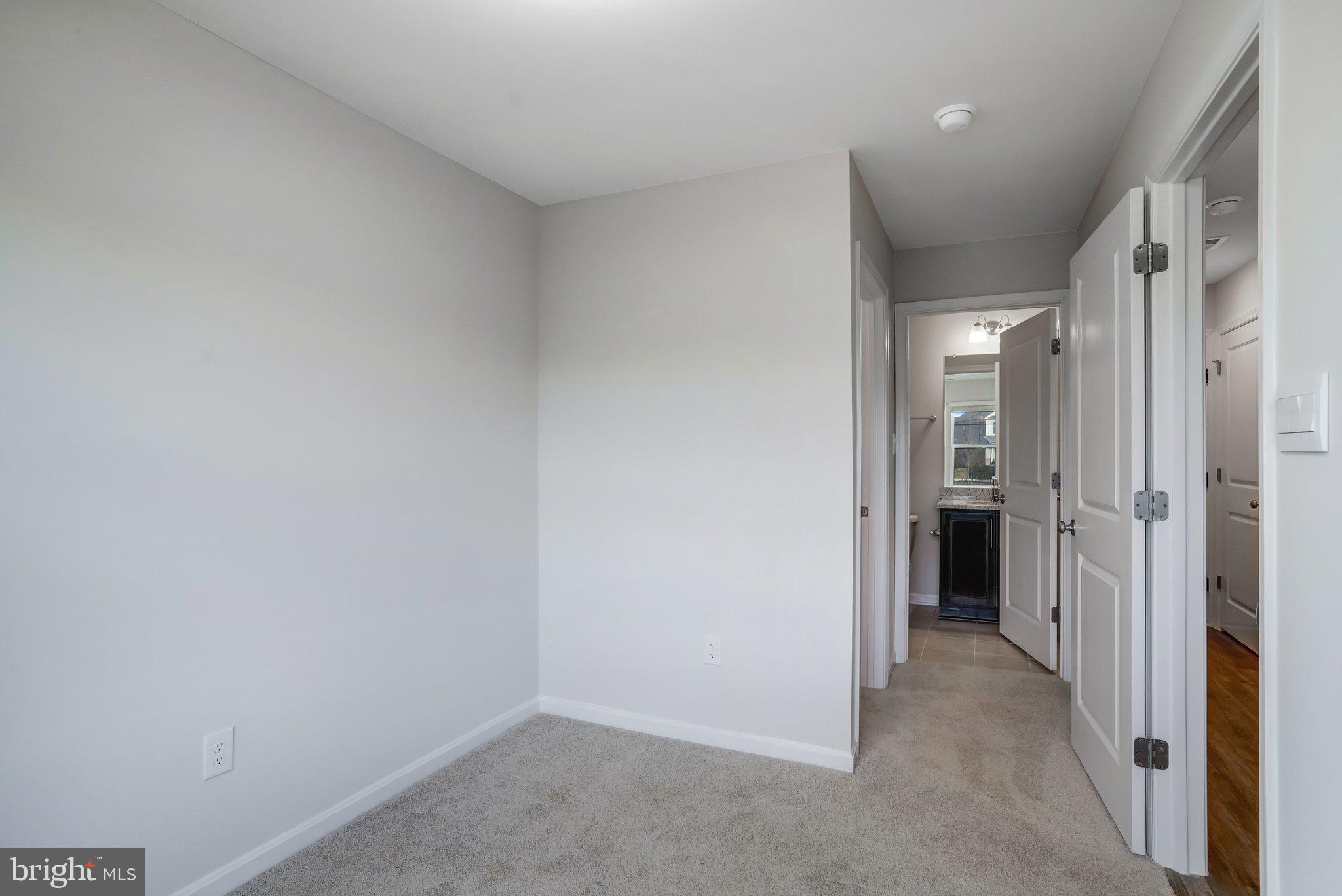 721 Courier Lane Frederick, MD 21701 - Photo 28 of 61 a view of a hallway with closet and wooden floor