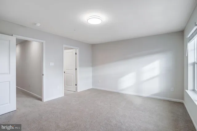 a view of a hallway with wooden floor and entryway