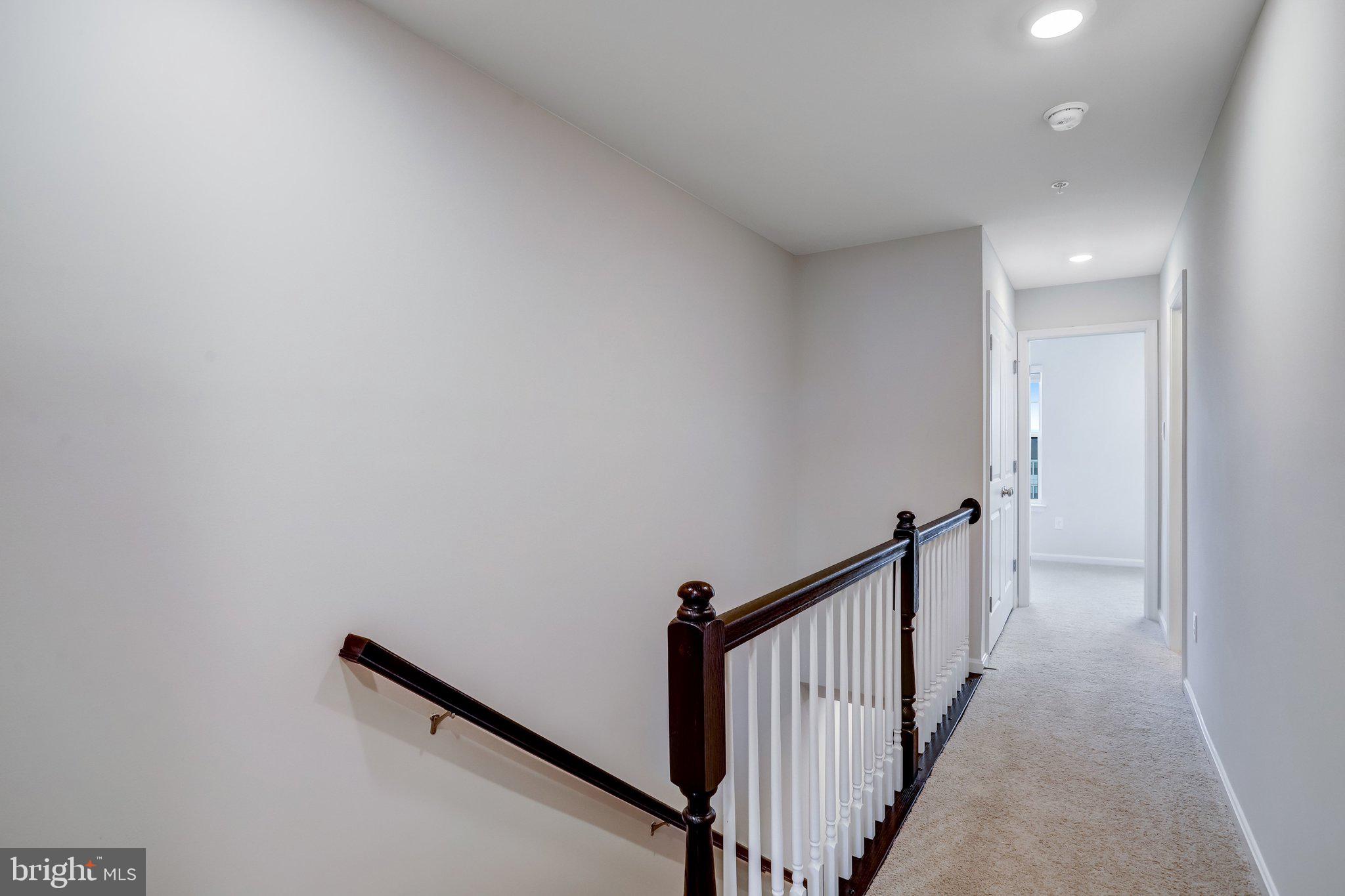 721 Courier Lane Frederick, MD 21701 - Photo 40 of 61 a view of a hallway with wooden floor and entryway