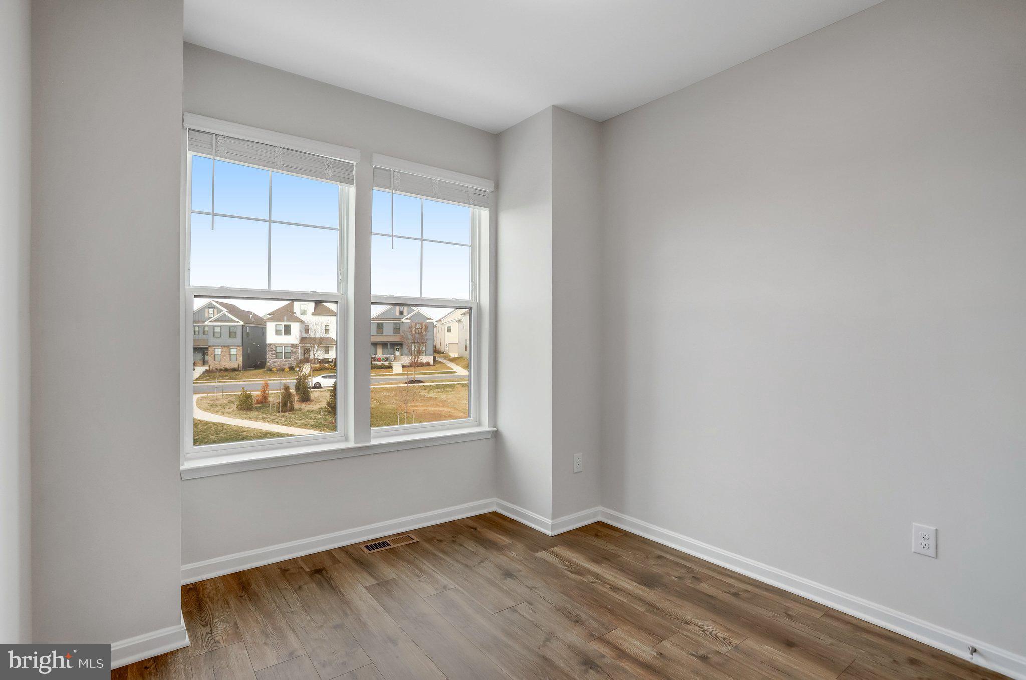 721 Courier Lane Frederick, MD 21701 - Photo 51 of 61 an empty room with wooden floor and windows