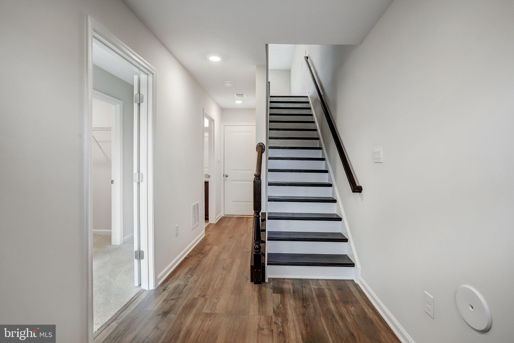 721 Courier Lane Frederick, MD 21701 - Photo 7 of 61 a view of a hallway with wooden floor and entryway