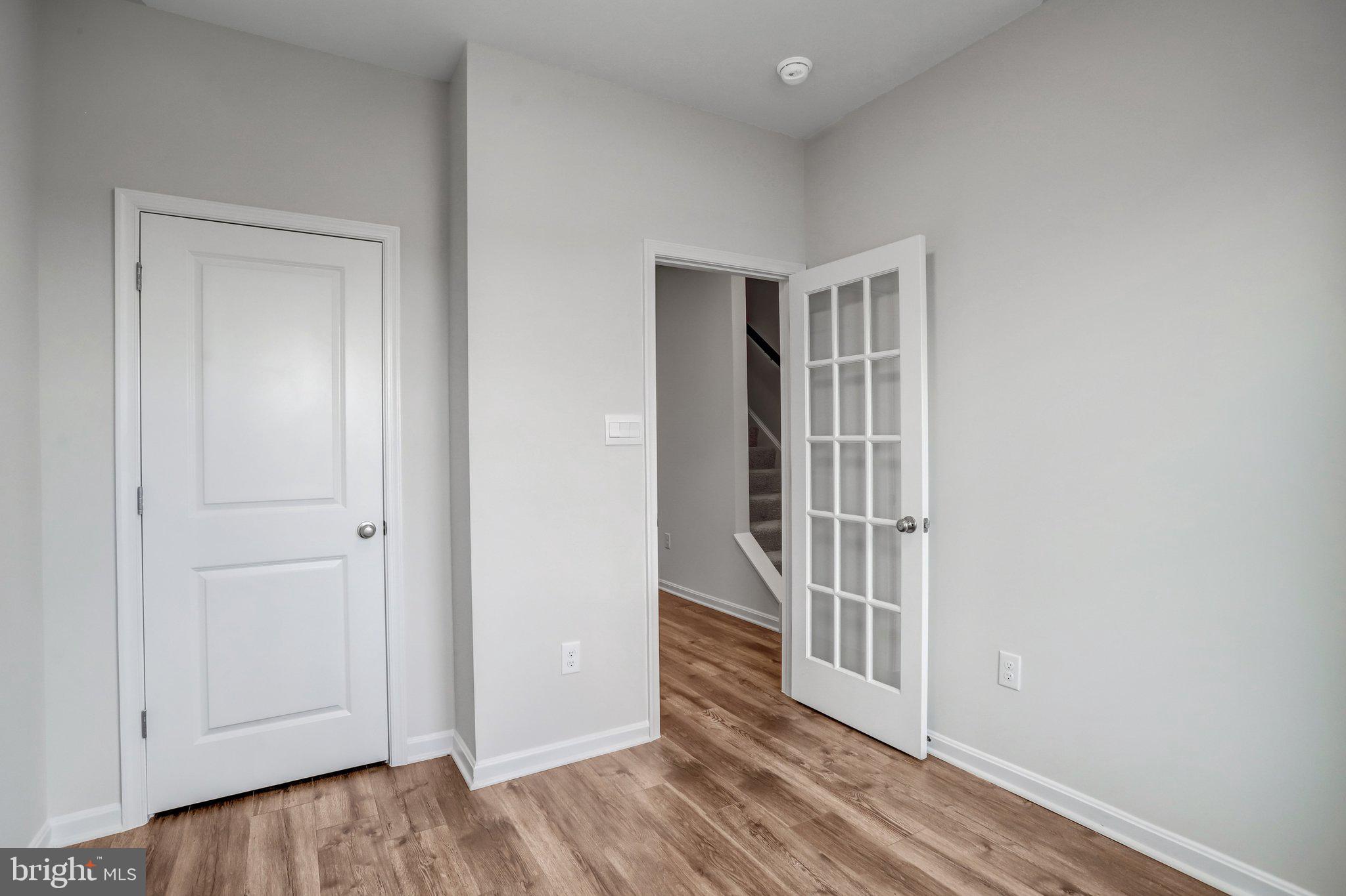 721 Courier Lane Frederick, MD 21701 - Photo 10 of 61 an empty room with wooden floor and windows