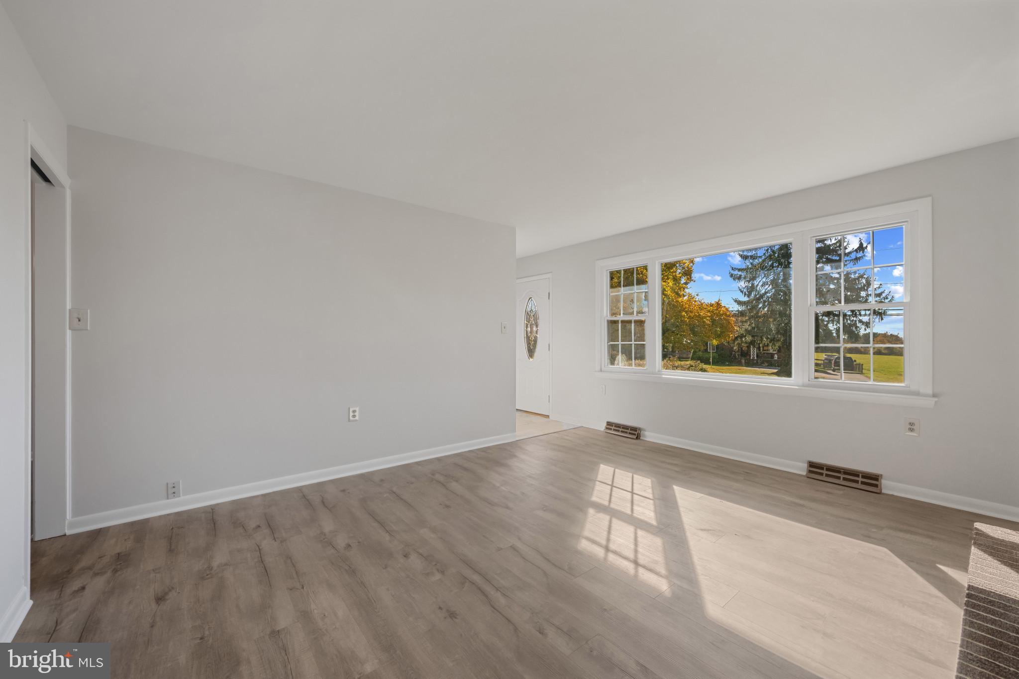 2106 Schuster Road Jarrettsville, MD 21084 - Photo 11 of 28 an empty room with wooden floor and windows