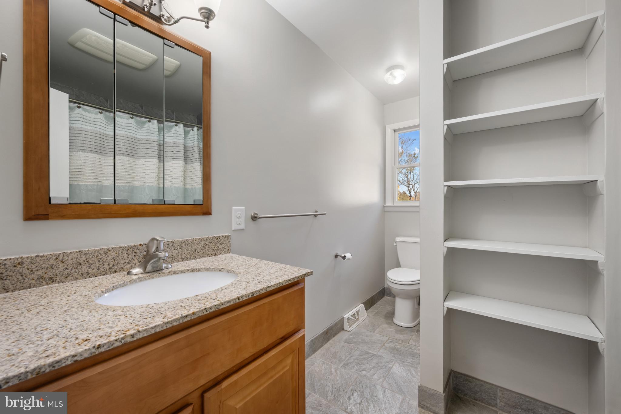 2106 Schuster Road Jarrettsville, MD 21084 - Photo 13 of 28 a bathroom with a granite countertop sink and a mirror