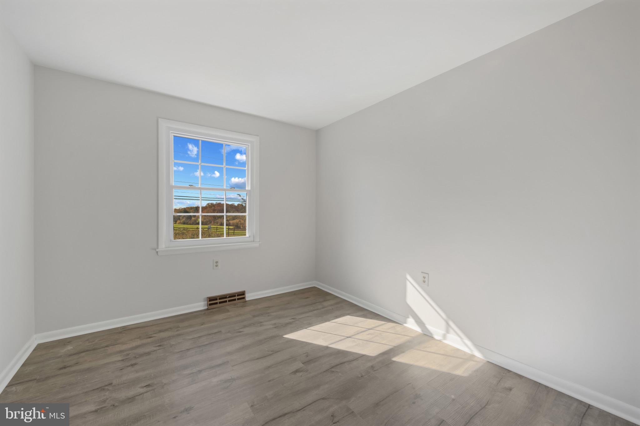 2106 Schuster Road Jarrettsville, MD 21084 - Photo 15 of 28 an empty room with wooden floor and windows