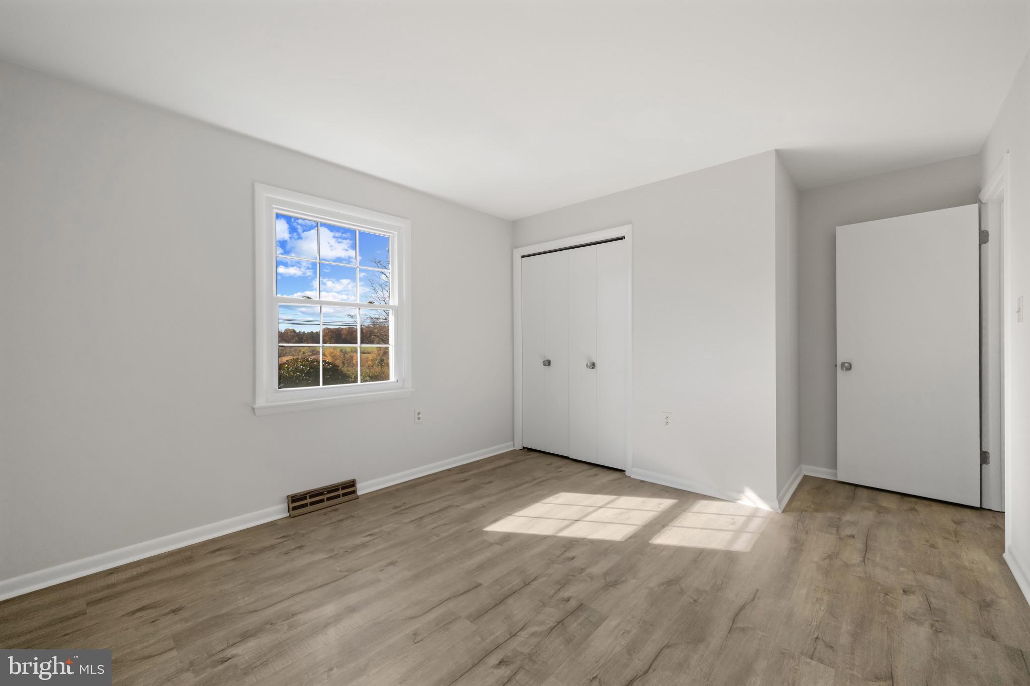 2106 Schuster Road Jarrettsville, MD 21084 - Photo 18 of 28 an empty room with wooden floor and windows