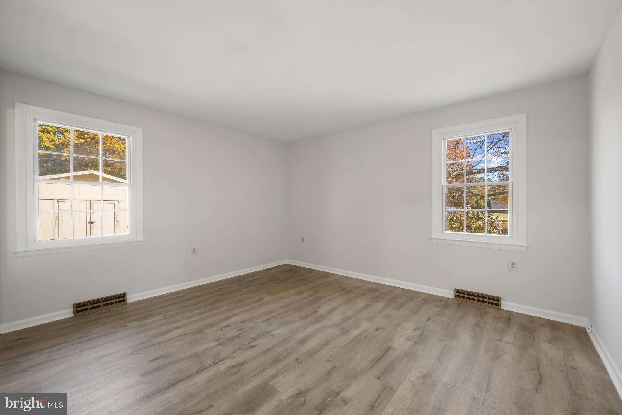 2106 Schuster Road Jarrettsville, MD 21084 - Photo 19 of 28 a view of an empty room with wooden floor and a window