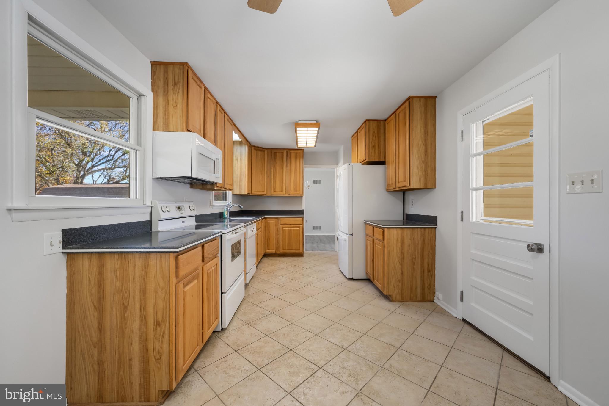 2106 Schuster Road Jarrettsville, MD 21084 - Photo 7 of 28 a kitchen with stainless steel appliances a sink stove and cabinets