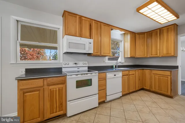 a kitchen with a stove a sink and a microwave
