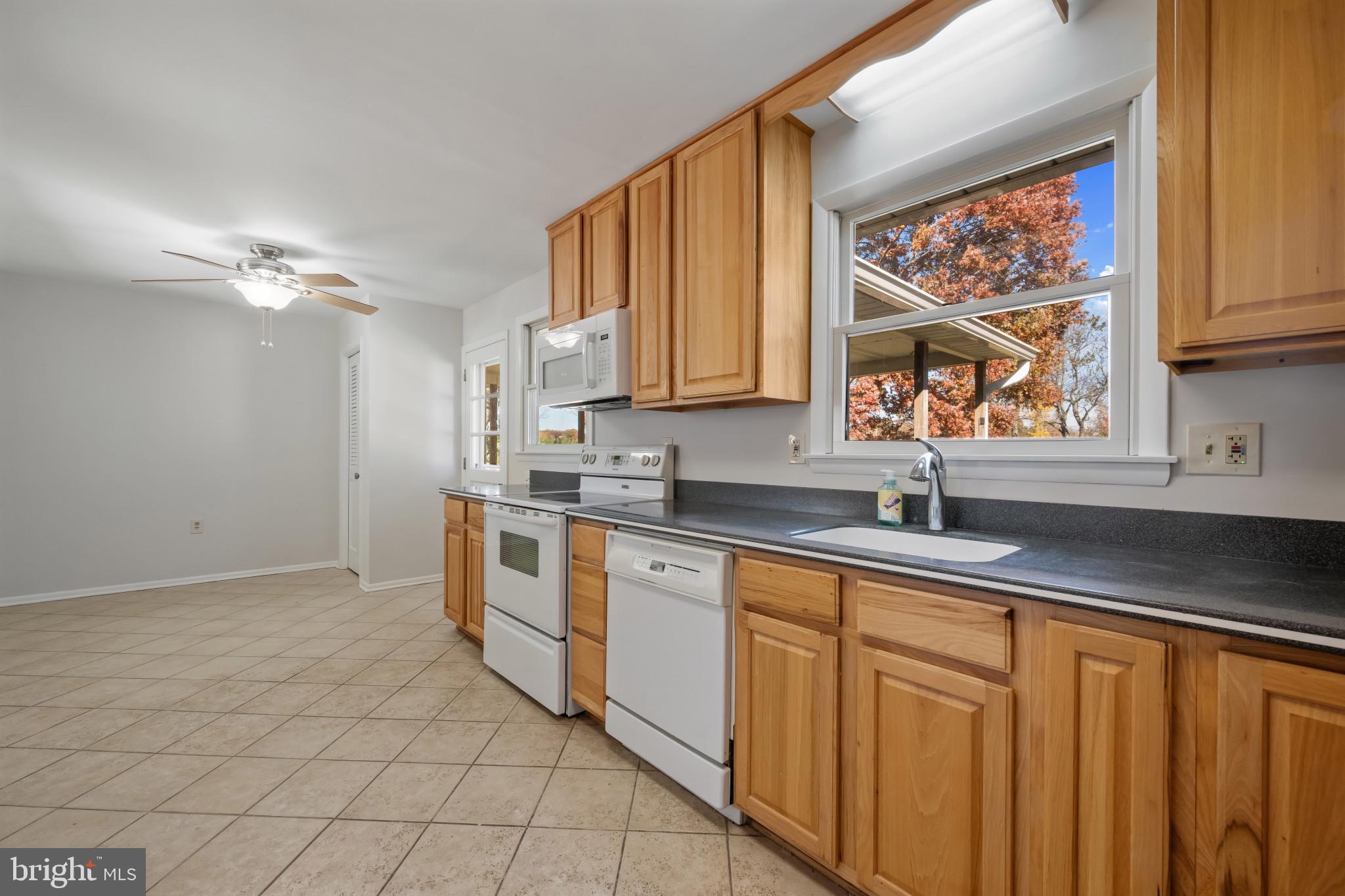 2106 Schuster Road Jarrettsville, MD 21084 - Photo 9 of 28 a kitchen with stainless steel appliances granite countertop a sink and cabinets with wooden floor