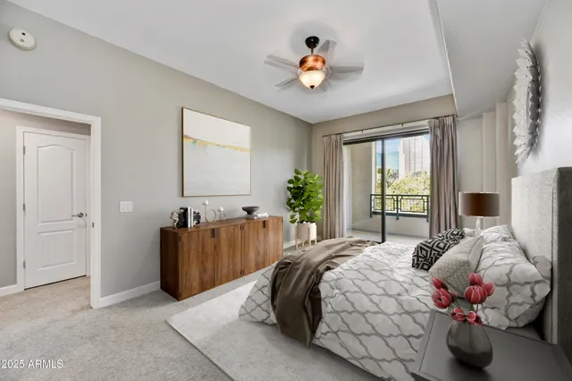 a bedroom with a bed and a chandelier