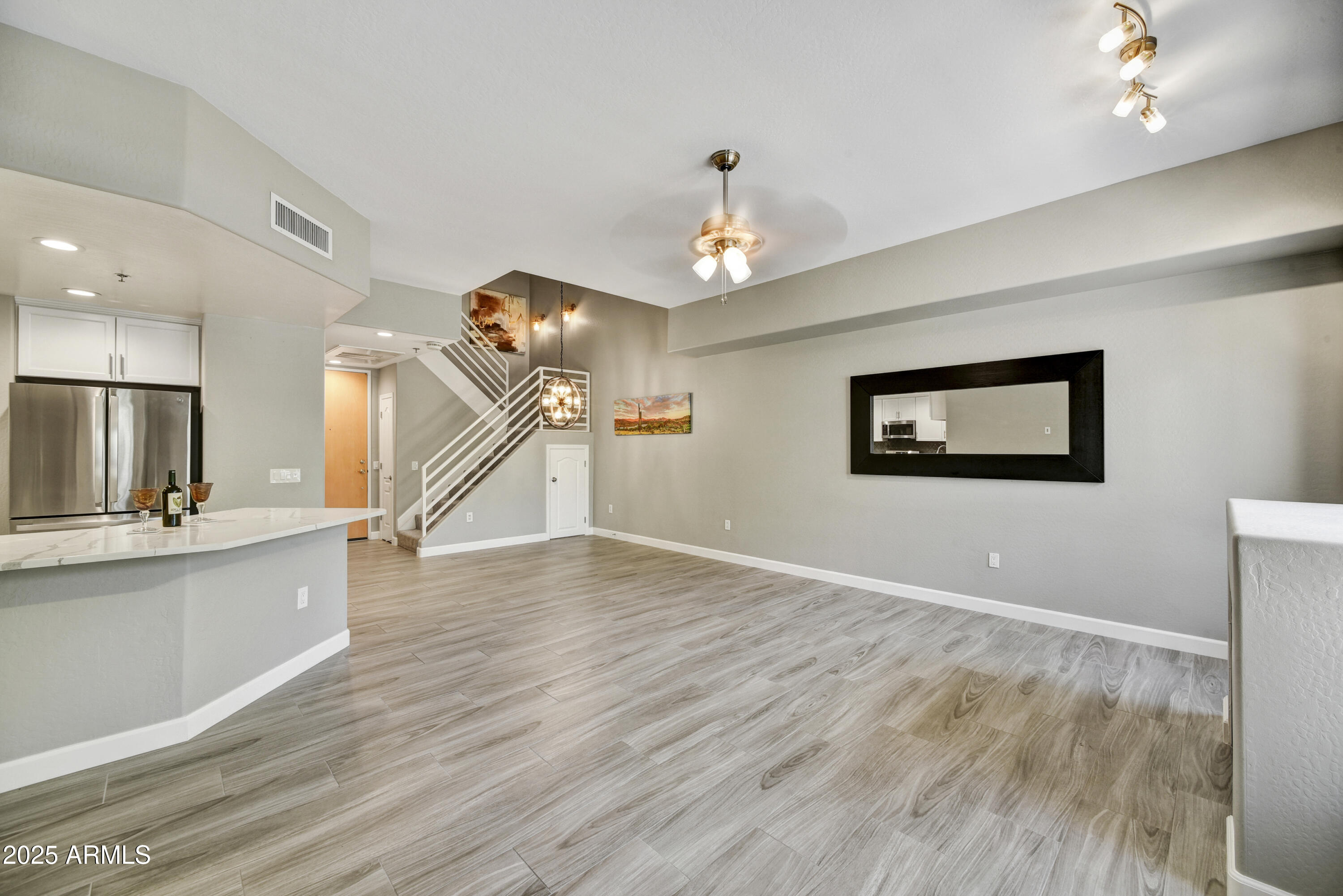 16 West Encanto Boulevard, Unit 22 Phoenix, AZ 85003 - Photo 2 of 34 a view of empty room with wooden floor and fan