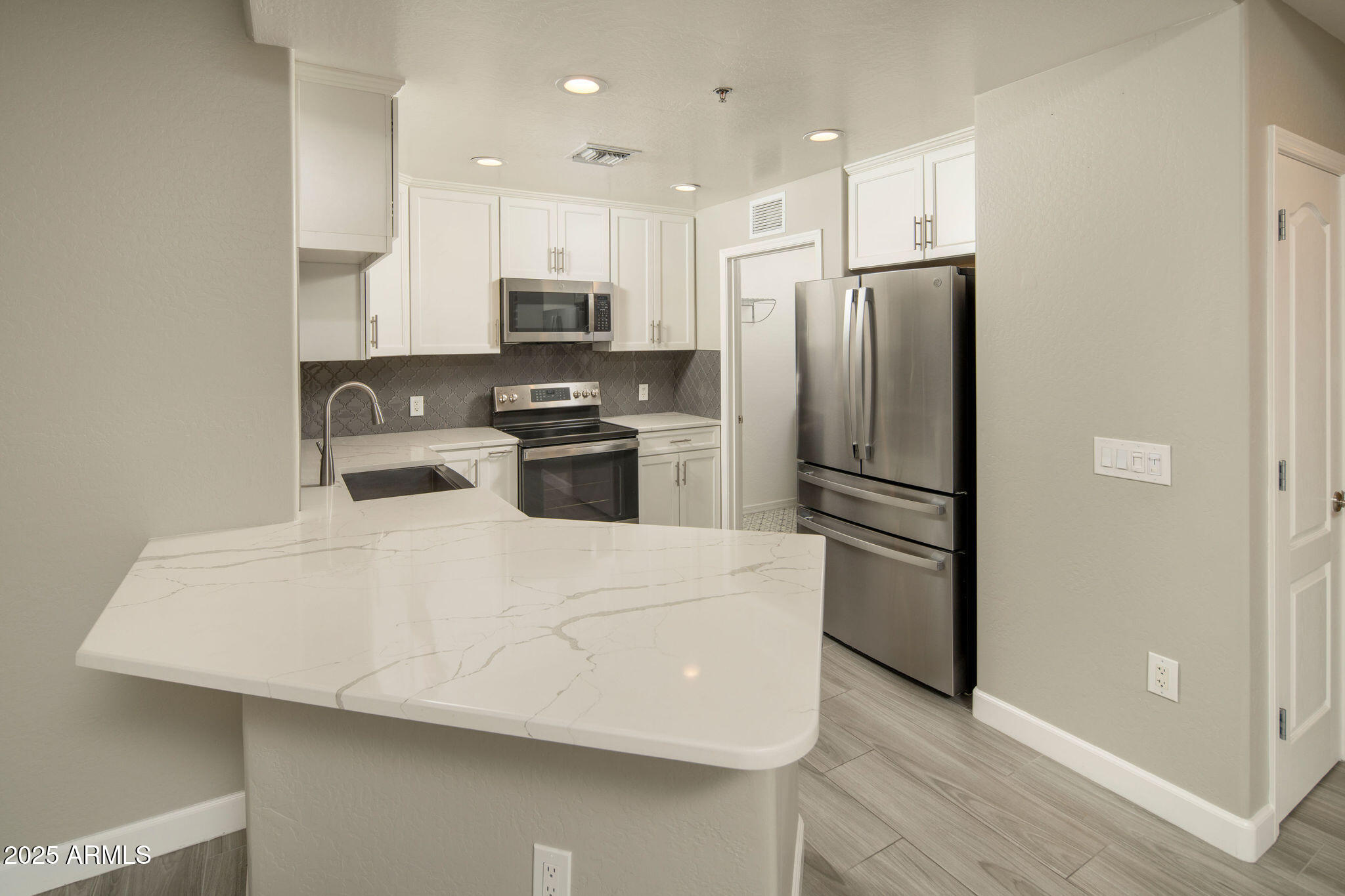 16 West Encanto Boulevard, Unit 22 Phoenix, AZ 85003 - Photo 7 of 34 a kitchen with stainless steel appliances a refrigerator sink and microwave