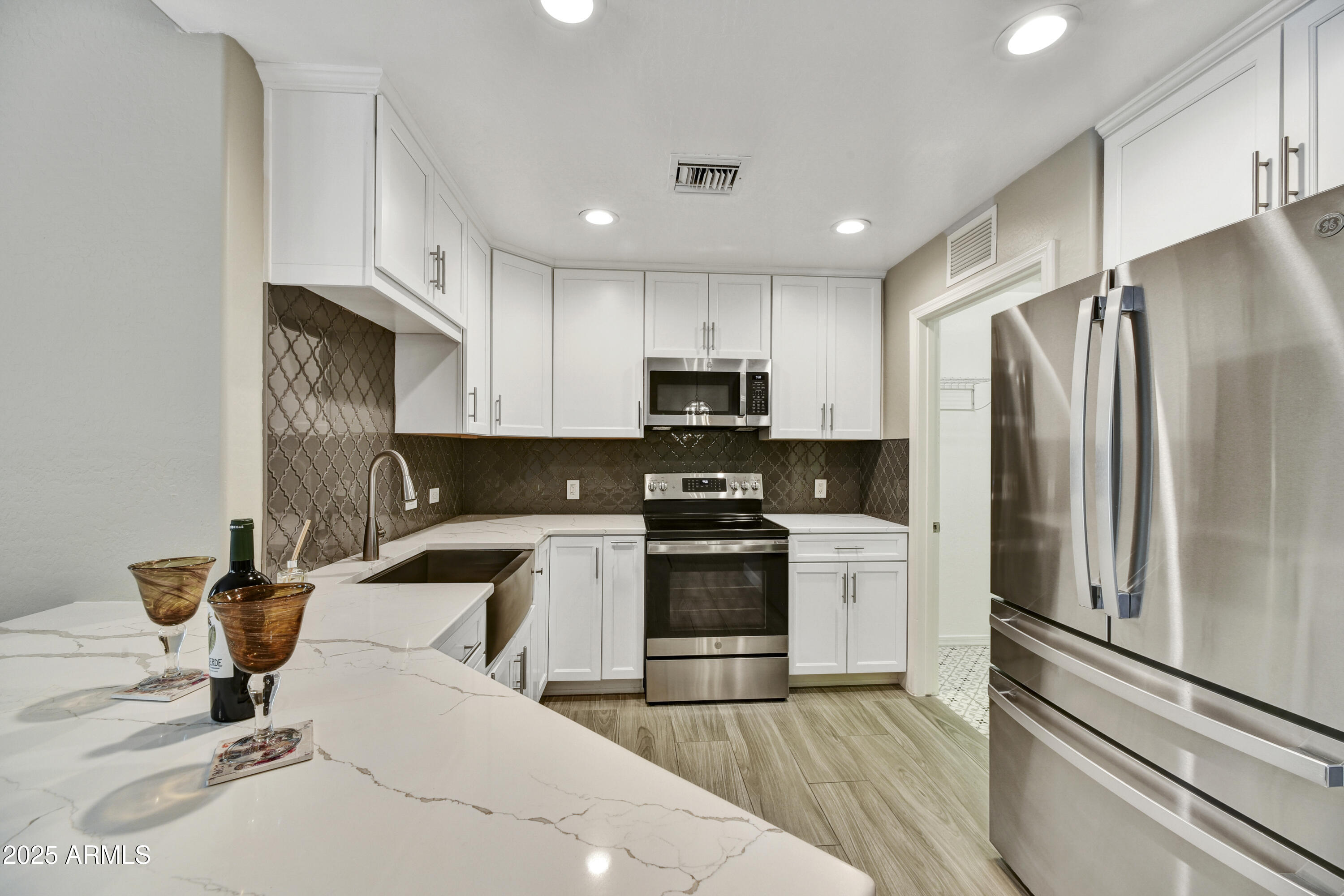 16 West Encanto Boulevard, Unit 22 Phoenix, AZ 85003 - Photo 8 of 34 a kitchen with a sink stainless steel appliances and cabinets