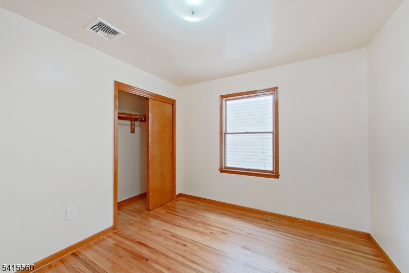 55 Ferguson Street, Unit 2 Newark, NJ 07105 - Photo 11 of 25 an empty room with wooden floor and windows