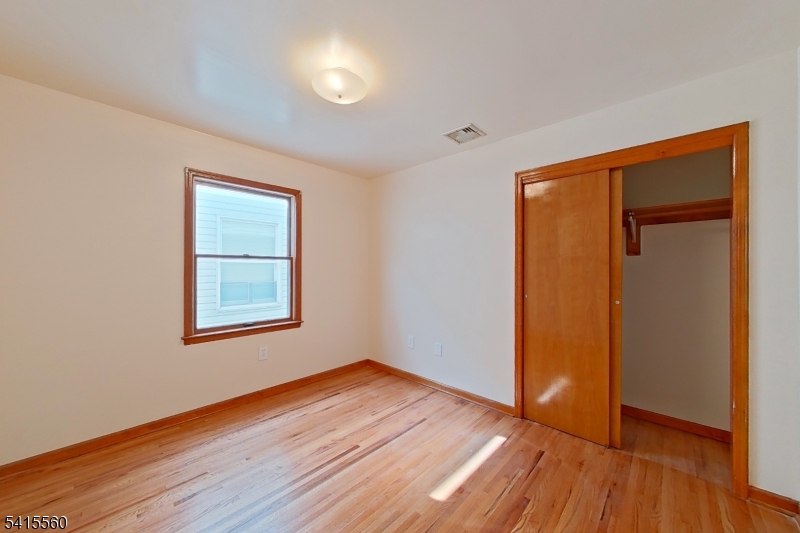 55 Ferguson Street, Unit 2 Newark, NJ 07105 - Photo 14 of 25 an empty room with wooden floor and a window