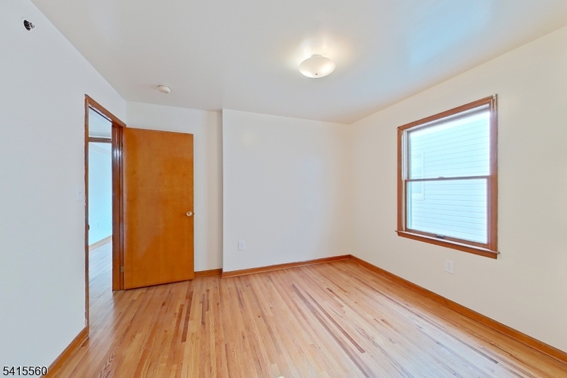 55 Ferguson Street, Unit 2 Newark, NJ 07105 - Photo 16 of 25 an empty room with wooden floor and windows
