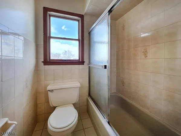 a white toilet sitting next to a bathroom sink and tub