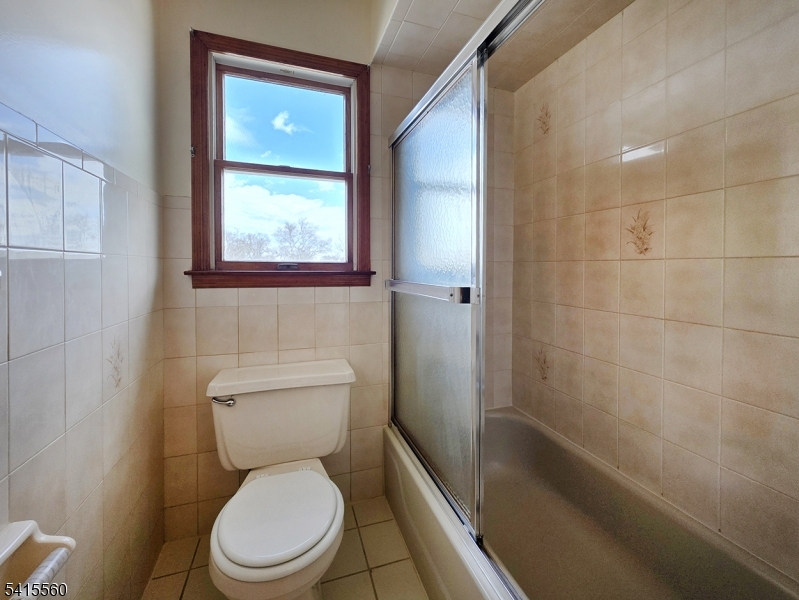55 Ferguson Street, Unit 2 Newark, NJ 07105 - Photo 23 of 25 a white toilet sitting next to a bathroom sink and tub
