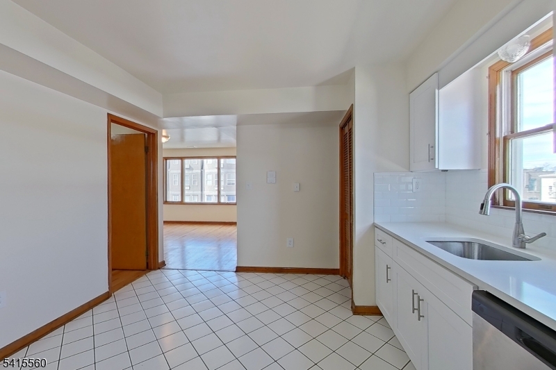 55 Ferguson Street, Unit 2 Newark, NJ 07105 - Photo 8 of 25 a kitchen with a sink cabinets and a window