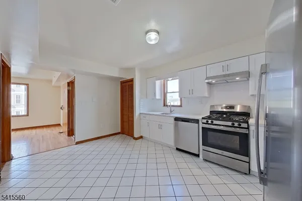 a kitchen with a stove and a refrigerator