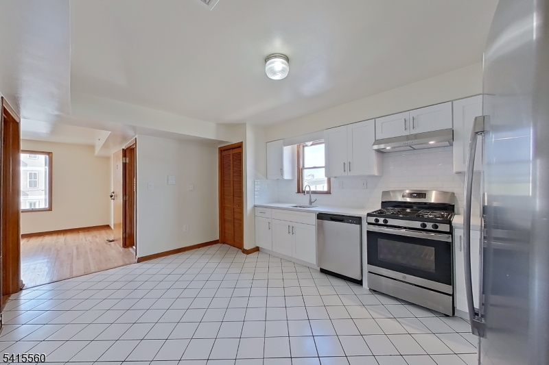 55 Ferguson Street, Unit 2 Newark, NJ 07105 - Photo 9 of 25 a kitchen with a stove and a refrigerator