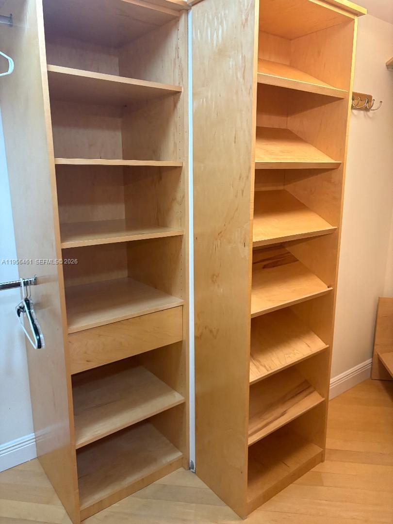 a view of walk in closet with empty racks