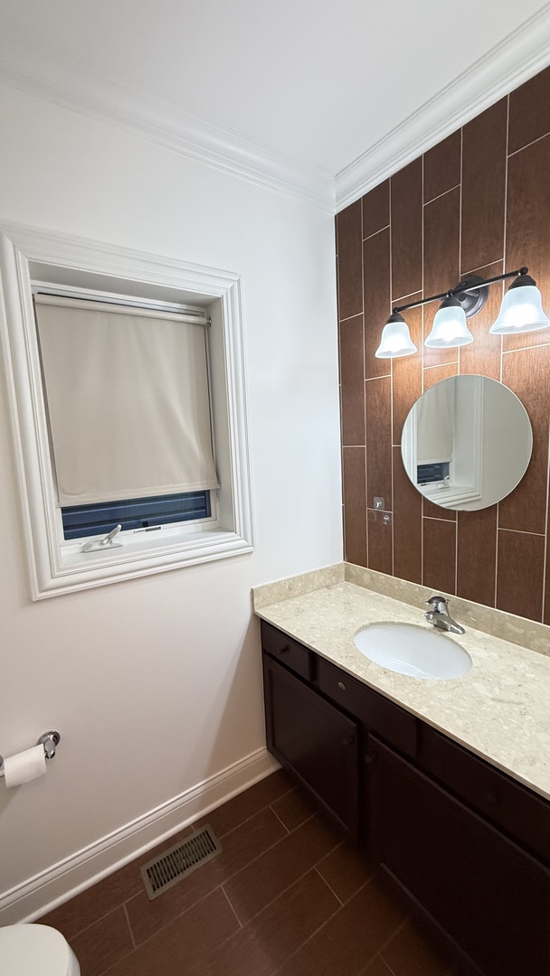 4411 South Wallace Street Chicago, IL 60609 - Photo 12 of 23 a bathroom with a sink and a mirror