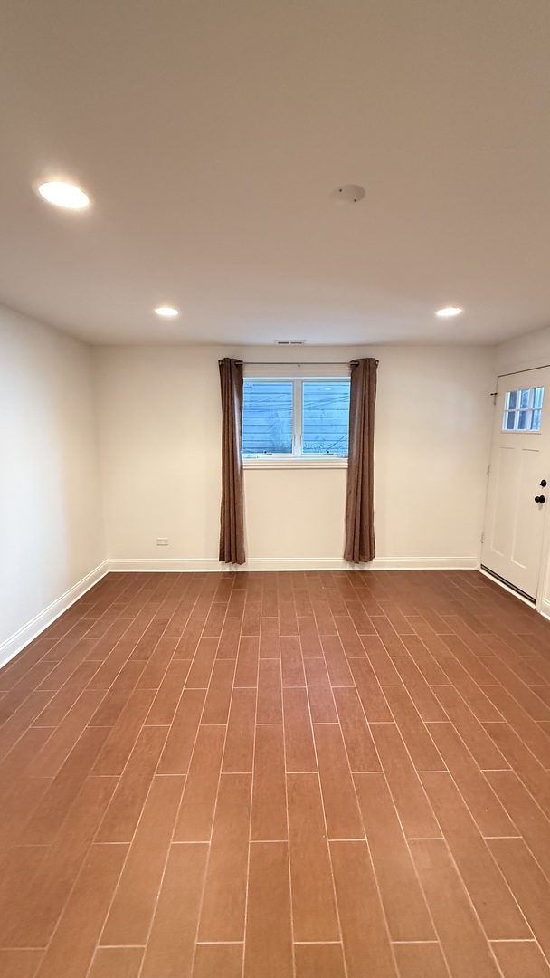 4411 South Wallace Street Chicago, IL 60609 - Photo 22 of 23 a view of an empty room with wooden floor