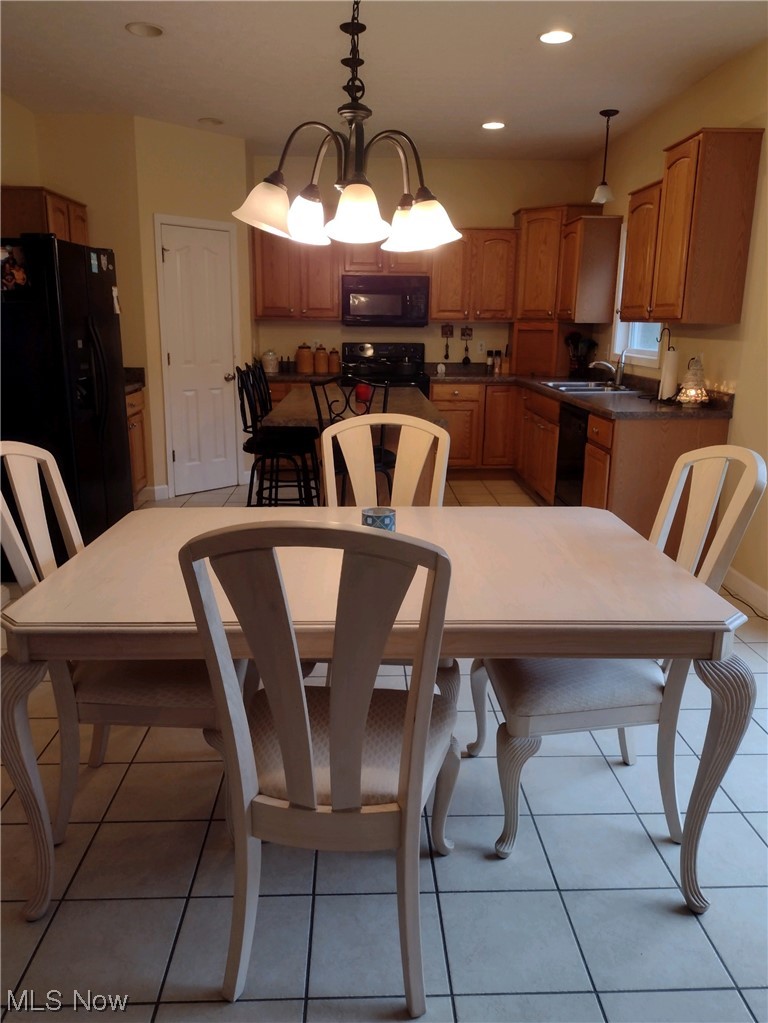 3270 Ridge Road Zanesville, OH 43701 - Photo 5 of 17 Tiled dining space with a chandelier and sink
