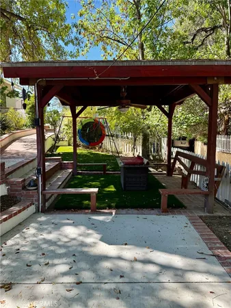 a view of backyard with deck and outdoor seating