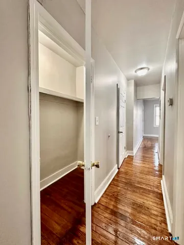 a view of a hallway with wooden floor
