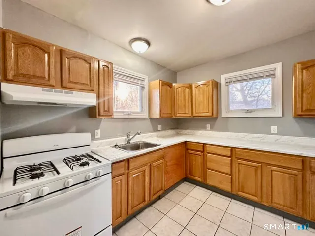 a kitchen with a sink stove and cabinets
