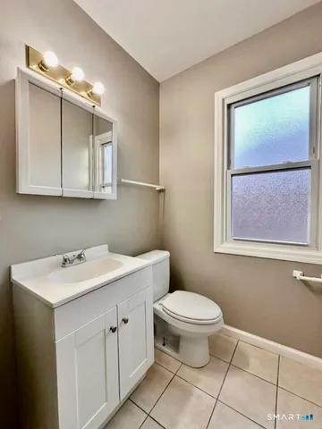a bathroom with a sink toilet and mirror