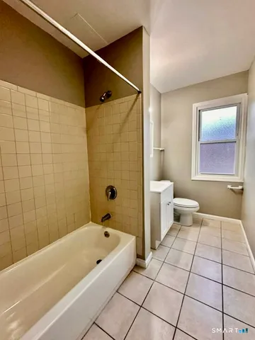 a bathroom with a bathtub and a toilet