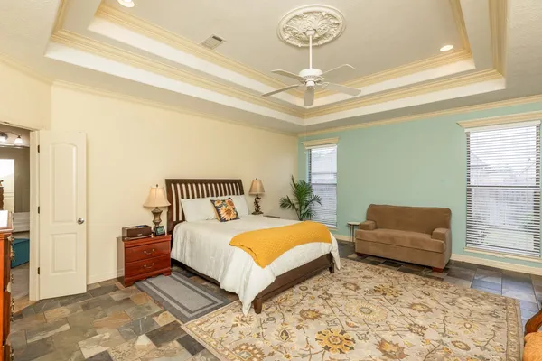 a bedroom with a bed and a couch