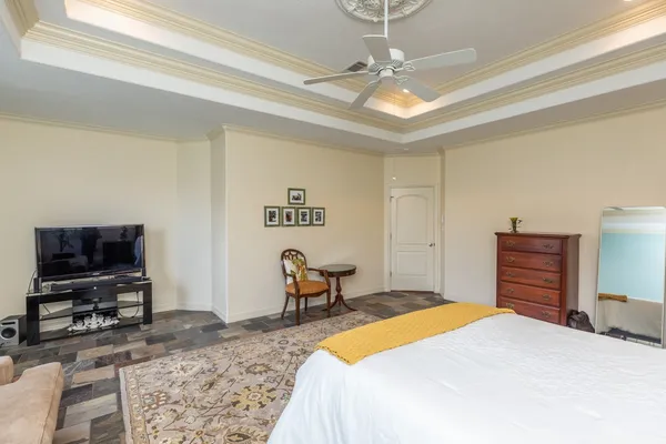 a bedroom with a bed and a flat screen tv