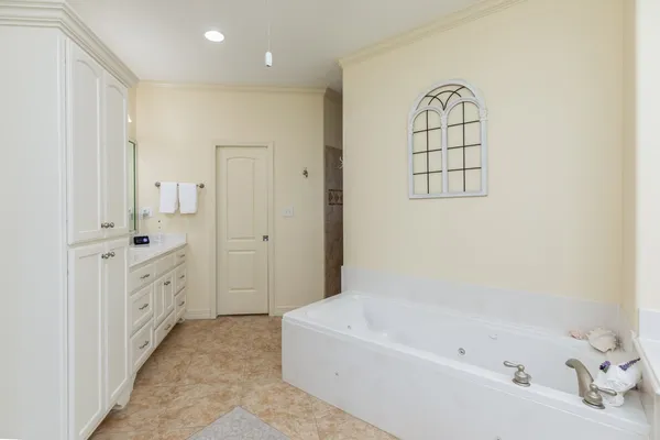 a bathroom with a bathtub a sink and a window