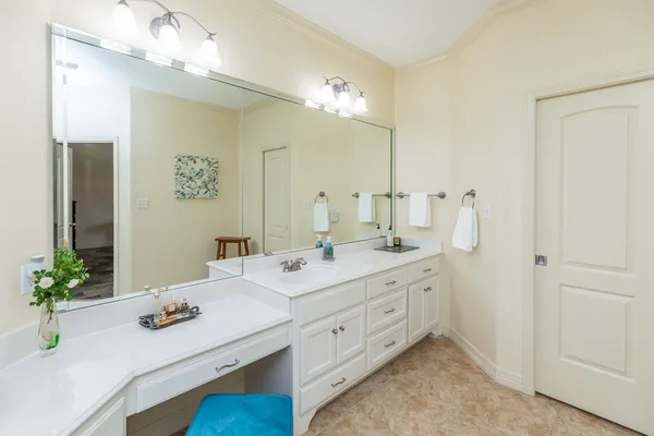 a bathroom with a granite countertop sink a large mirror and a shower