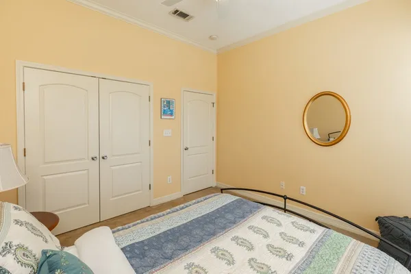 a bedroom with a bed and a mirror