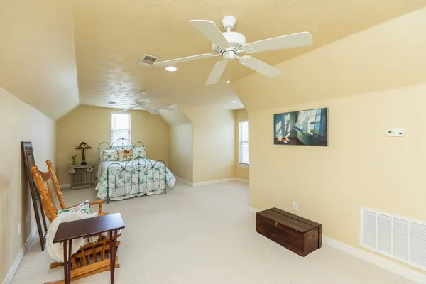 a living room with furniture and a ceiling fan
