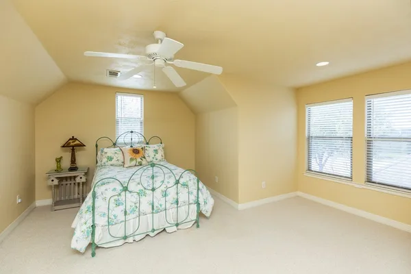 a bedroom with a bed and ceiling fan
